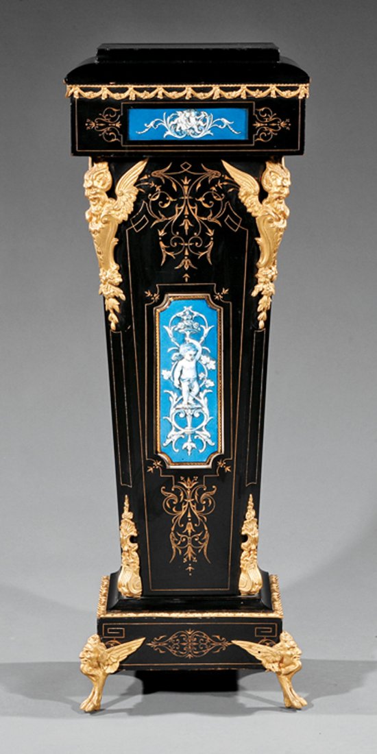 Ebonized, Gilt Bronze, Porcelain-Mounted Pedestal: Belle Epoque Ebonized, Gilt Bronze and Porcelain-Mounted Pedestal, late 19th c., stepped molded top, incised frieze, chamfered support, plinth base, winged hoof feet, h. 41 5/8 in., w. 14 7/8 in., d. 