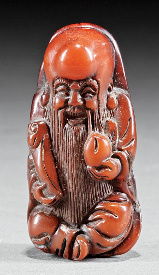 Chinese Horn Figural Pendant: Chinese Horn Figural Pendant, carved as Shoulao carrying a peach and scepter resting on a leaf, h. 2 3/4 in