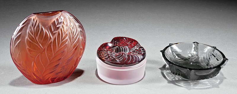 Lalique "Filicara" Amber Glass Bud Vase: Lalique "Filicara" Amber Glass Bud Vase, engraved "Lalique France", molded with floral pattern, h. 4 3/4 in; together with a gray star pattern ashtray; "Snake" ruby glass box lid; and small clear glas