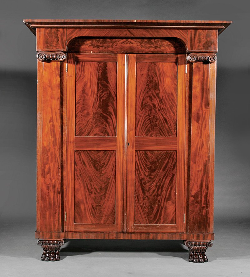 American Classical Carved Mahogany Armoire: American Classical Carved Mahogany Armoire, early 19th c., probably Baltimore, flared cornice, inset arch frieze, paneled doors flanked by Ionic columnar pilasters, shelf interior, each end with panel