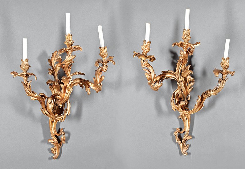 Pair of Louis XV-Style Gilt Bronze Sconces: Pair of Louis XV-Style Gilt Bronze Three-Light Sconces, probably 19th c., foliate scroll backplate and candlearms, h. 34 in., w. 16 in., electrified. Provenance: The Gotlib Collection