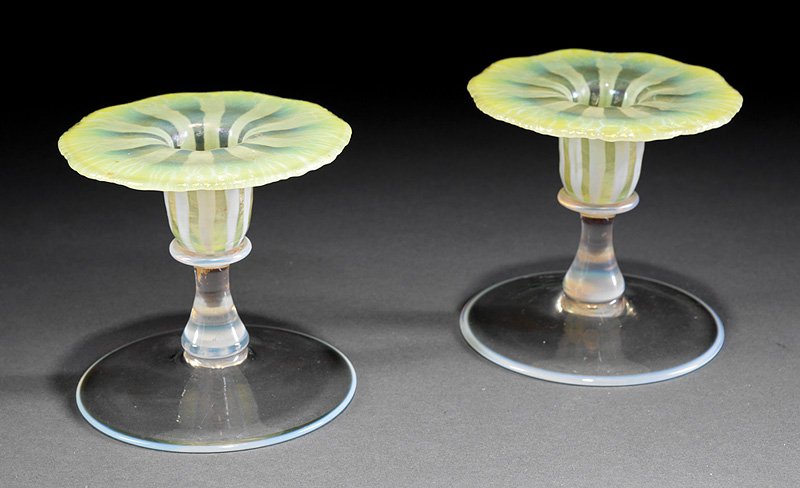 Tiffany Favrile Yellow Pastel Glass Candlesticks: Pair of Tiffany Favrile Yellow Pastel Glass Candlesticks, each marked, h. 3 3/4 in. Provenance: accompanied by a copy of the M.S. Rau, Inc., New Orleans invoice, dated Aug. 3, 1988; New Orleans Estate