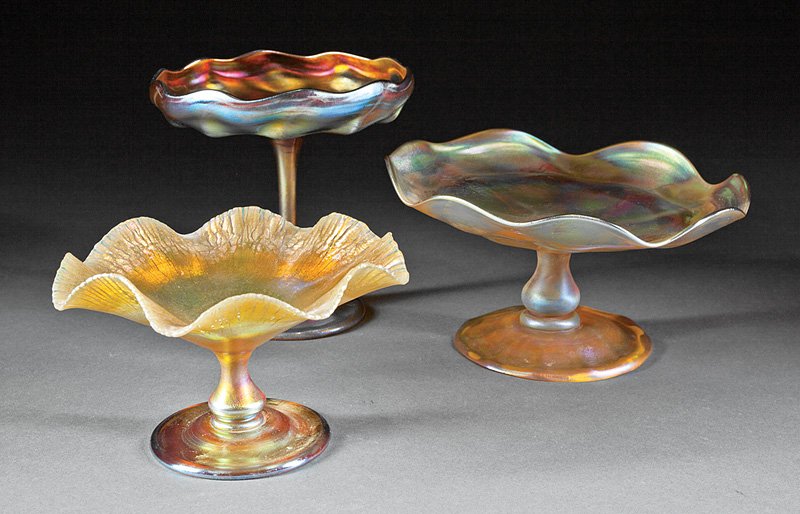 Three Tiffany Favrile Glass Compotes: Three Tiffany Favrile Glass Compotes, each marked, one with onion skin finish, tallest h. 6 in. Provenance: New Orleans Estate