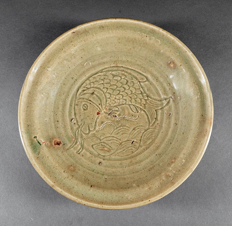 Chinese Celadon Pottery Tripod Bowl: Chinese Celadon Pottery Tripod Bowl, probably Ming Dynasty (1368-1644), interior carved with fish and waves, h. 3 in., dia. 12 1/4 in. Provenance: New Orleans Estate