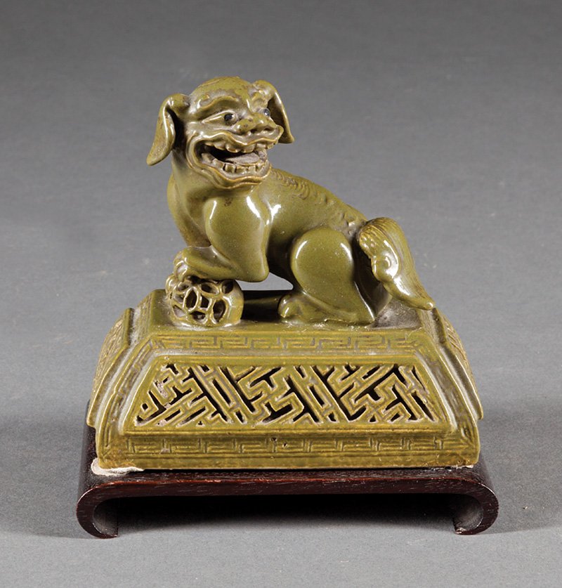 Chinese Green-Glazed Pottery Cover: Chinese Green-Glazed Pottery Cover, probably Qing Dynasty (1644-1911), canted rectangular base with Buddhist lion finial, h. 4 3/4 in., wood stand, overall h. 5 1/2 in. Provenance: New Orleans Estate