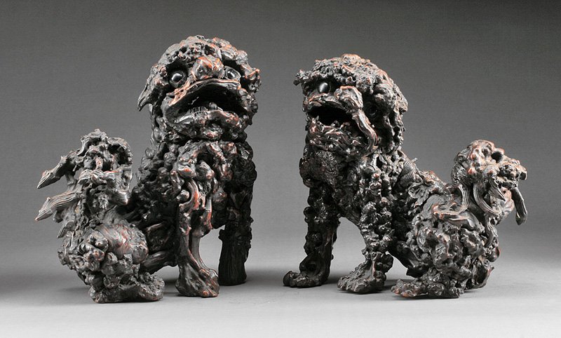 Chinese Rootwood Figures of Buddhist Lions: Pair of Chinese Rootwood Figures of Buddhist Lions, each carved seated on its haunches, largest h. 12 in