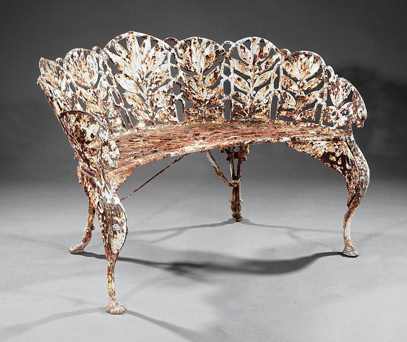 Pair "Laurel" Pattern Settees, after Coalbrookdale: Pair of Antique American or English Cast Iron "Laurel" Pattern Settees, 19th c., after the Coalbrookdale model, foliate-carved backs, conforming arms, pierced incurvate seats, winged griffin legs, tri