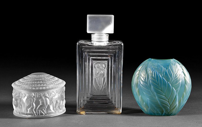 Three Lalique Art Glass Pieces: Three Lalique Art Glass Pieces, each marked, incl. a "Filicara" green bud vase, h. 4 1/2 in.; an "Enfants" lidded box, h. 3 1/4 in.; and a "Duncan" perfume bottle, h. 7 7/8 in. Note: Repaired stopper