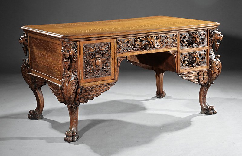 Partner's Desk, c. 1880-1900, probably R.J. Horner: American Carved Oak Partner's Desk, c. 1880-1900, probably R.J. Horner, New York, molded rectangular top, kneehole configuration of drawers and cupboard with lion's masks, canted winged griffin legs, 