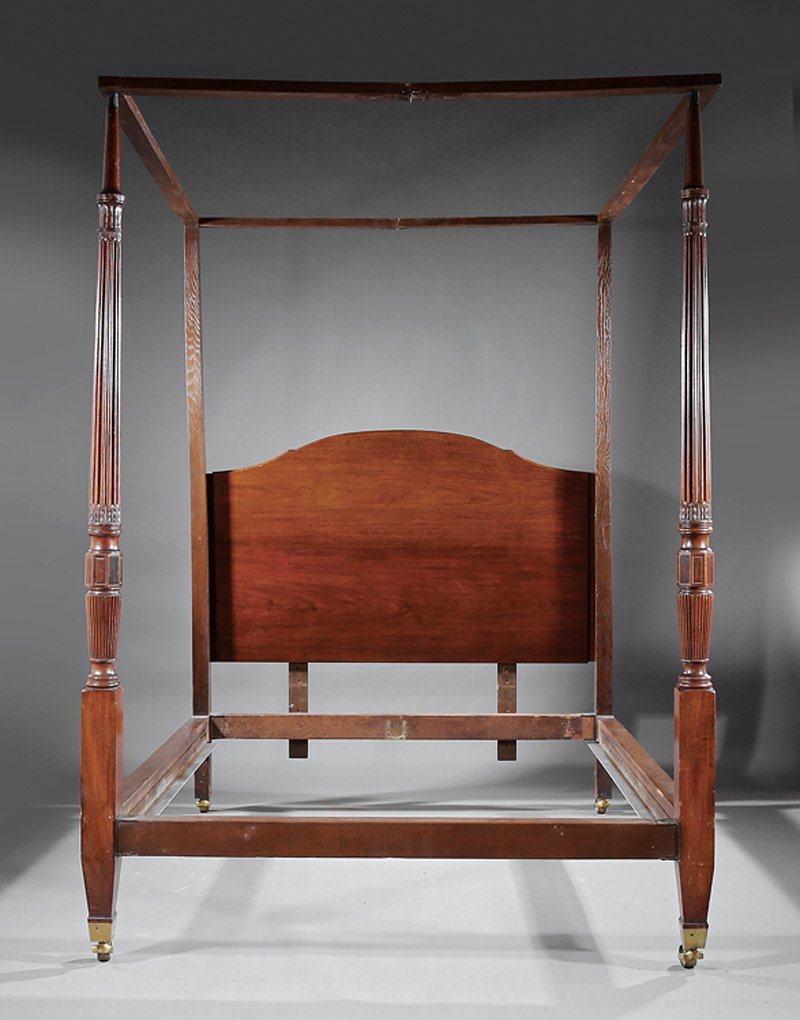 American Federal-Style Carved Mahogany Four Post Bed: American Federal-Style Carved Mahogany Four Post Bed, 19th c. and later, molded tester, arched headboard, plain headposts with antique reeded husk carved foot posts, later rails, cuff casters, h. 93 1