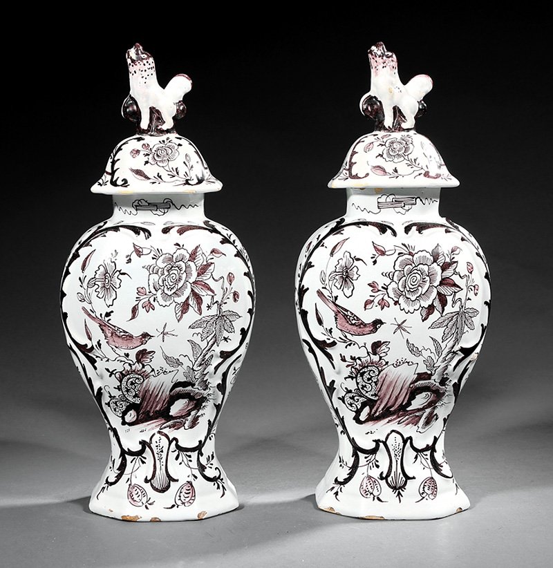 Delft Manganese and White Pottery Covered Vases: Pair of Delft Manganese and White Pottery Covered Garniture Vases, 18th/19th c., faceted baluster bodies molded with leafy vines enclosing bird, rock and flower scenes, faceted domed covers with "foo"