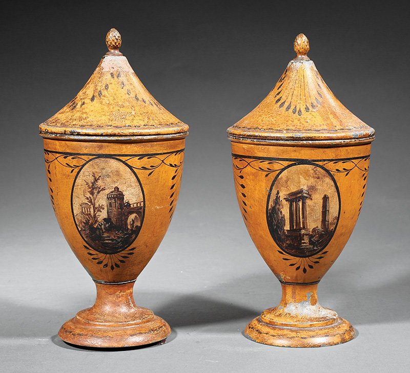 Pair of Continental Tôle Peinte Lidded Urns: Pair of Continental Tôle Peinte Lidded Urns in the Neoclassical Taste, 19th c., ochre ground with landscape vignettes, h. 10 1/4 in