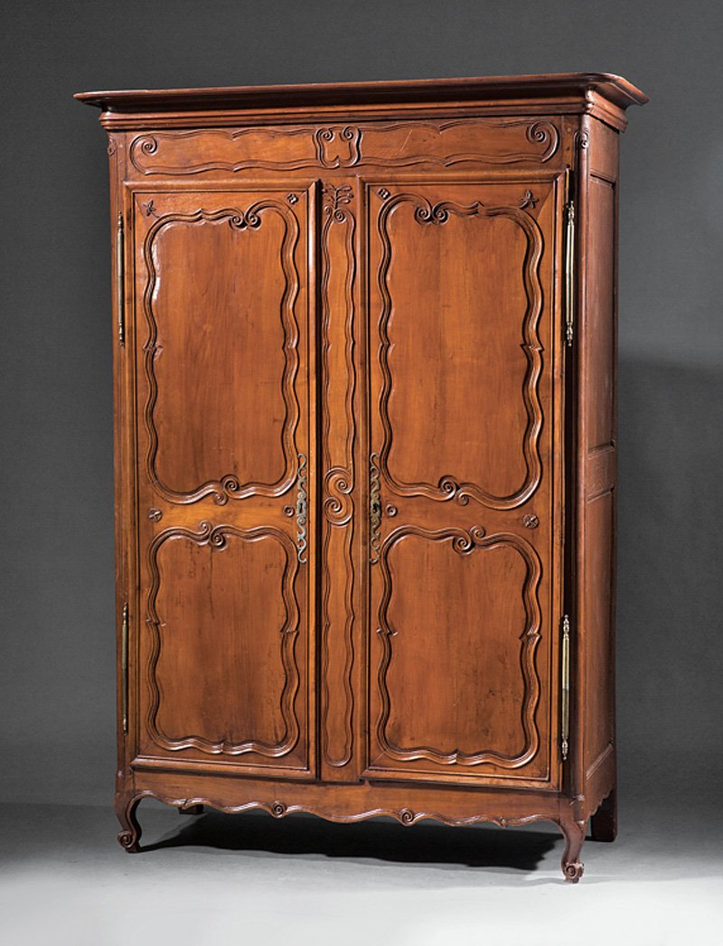 French Provincial Carved Fruitwood Armoire: Louis XV-Style French Provincial Carved Fruitwood Armoire, stepped cornice, raised panel doors, shaped apron, scrolled feet, h. 87 1/2 in., w. 61 3/4 in., d. 25 5/8 in. Provenance: Antique de Provence