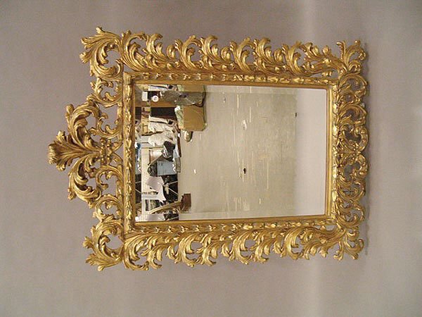 A Giltwood Mirror , the beveled glass within bold