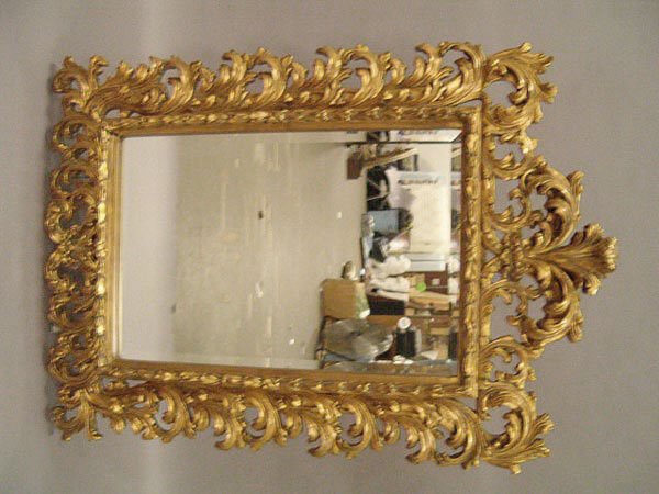 A Giltwood Mirror , the beveled glass set within