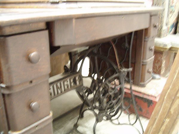 An Antique Singer Sewing Machine and Table , c. 1: An Antique Singer Sewing Machine and Table , c. 1880, cast iron trestle base, oak case with a pair of three square drawers, enclosing the original Singer sewing machine in good condition, table height