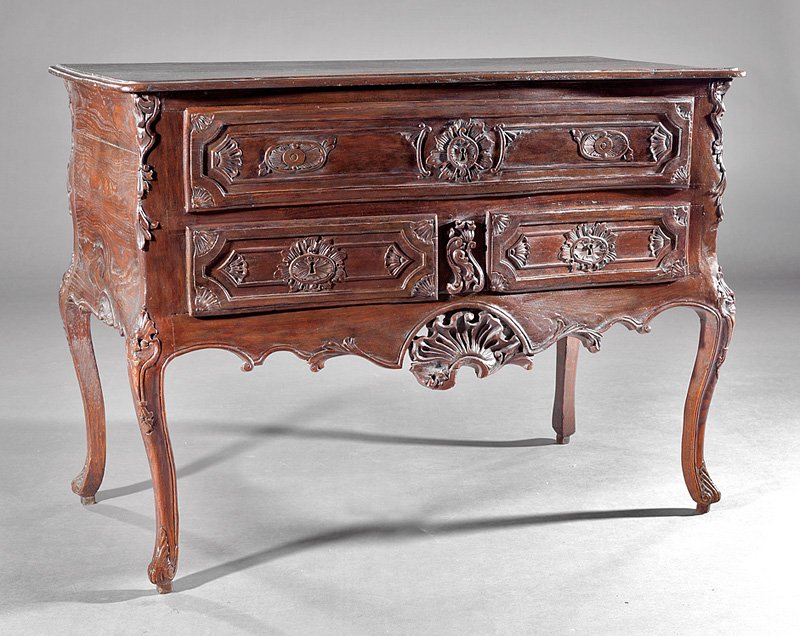 Portuguese Rococo Carved Walnut Commode: Portuguese Rococo Carved Walnut Commode, 18th c., serpentine molded top, one long over two short drawers, shell and foliate skirt, cabriole legs, h. 34 1/2 in., w. 46 3/4 in., d. 23 1/4 in