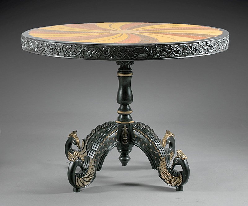 Parcel Gilt, Inlaid and Ebonized Center Table: Anglo-Colonial Parcel Gilt, Inlaid and Ebonized Center Table, circular top with radial exotic wood inlay, foliate-carved skirt, baluster standard, peacock-carved supports, h. 30 3/4 in., dia. 48 in