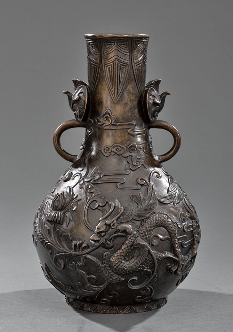 Chinese Bronze Bottle Vase: Chinese Bronze Bottle Vase, probably Qing Dynasty (1644-1911), with floral scroll handles, relief cast with dragons, lotus and foliage, base with Qianlong mark, h. 11 3/4 in., dia. 8 in