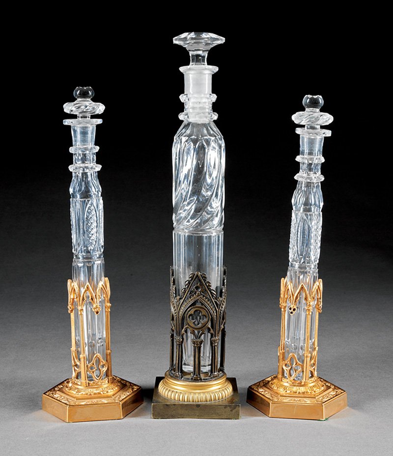 Three Gilt Bronze-Mounted Glass Scent Bottles: Three Gilt Bronze-Mounted Glass Scent Bottles in the Gothic Taste, incl. a tall ribbed form, h. 12 3/4 in.; and a pair of faceted and cut forms, h. 10 3/4 in. Provenance: Historic "Sally Mill", Middle