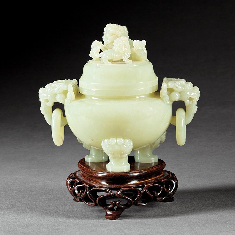 Chinese Celadon Jade Covered Tripod Censer: Chinese Pale Yellowish-Celadon Jade Covered Tripod Censer, probably early 20th c., carved with lion's mask loose ring handles and lion's mask feet, cover surmounted by a Buddhist lion, pup and brocade