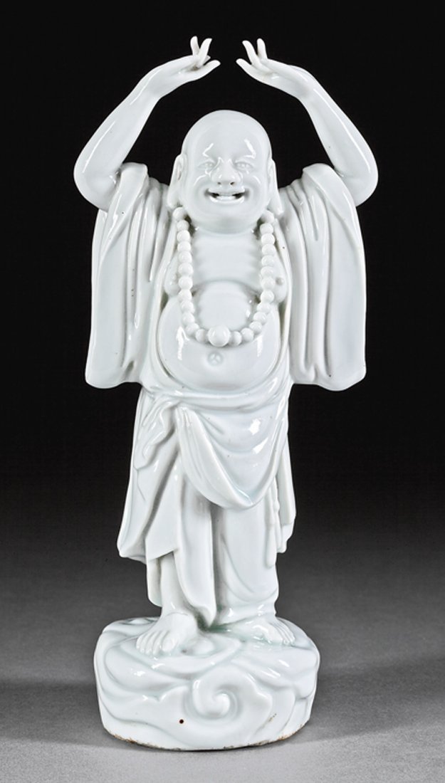 Chinese "Blanc de Chine" Porcelain Figure Budai: Chinese "Blanc de Chine" Porcelain Figure of Budai, probably Qing Dynasty (1644-1911), modeled with hands raised over head, h. 9 3/8 in. Provenance: Coleman E. Adler & Sons, New Orleans, Sept. 1981; E