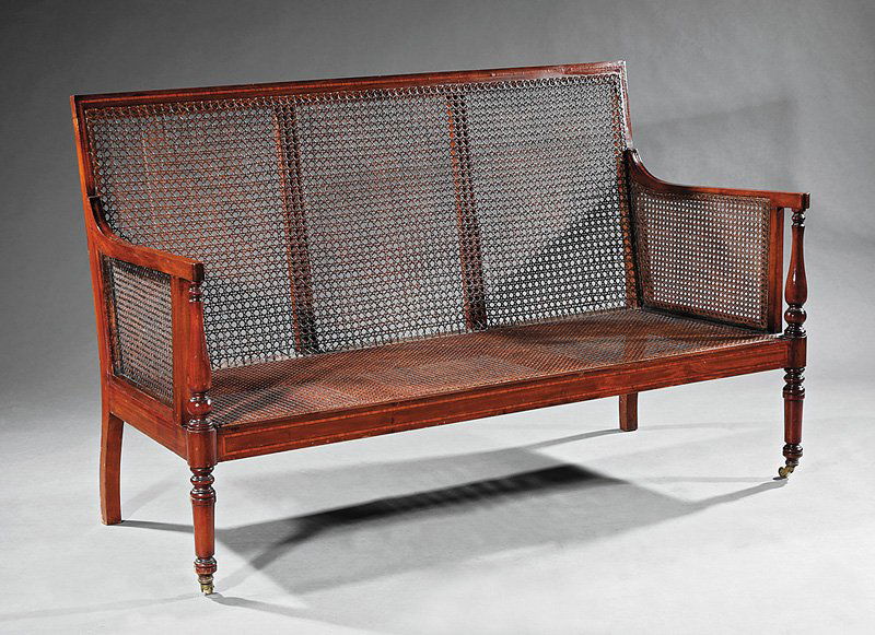 Edwardian Mahogany Caned Settee: Edwardian Mahogany Caned Settee, closed panel back and arms, baluster uprights, tapered legs, casters, h. 37 in., w. 61 1/2 in., d. 23 in
