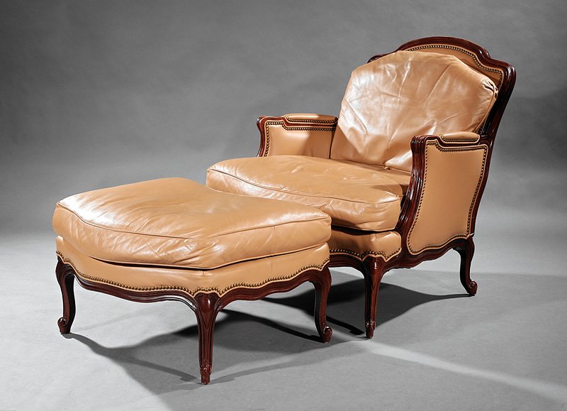 Carved Walnut and Leather Duchesse Brisee: Louis XV-Style Carved Walnut and Leather Duchesse Brisee, labeled Hancock & Moore, shaped back, padded scrolled arms, serpentine seat, cabriole legs, armchair h. 36 in., w. 34 in., d. 39 in., ottoman 