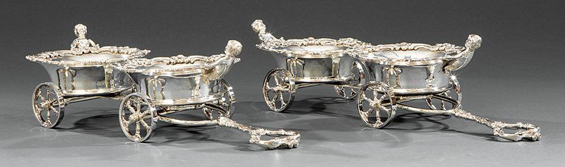 Decorative Silverplate Figural Decanter Trolleys: Pair of Decorative Silverplate Figural Decanter Trolleys, each moveable carriage fitted with two coasters mounted with putti, turned wood bottoms, l. 21 in