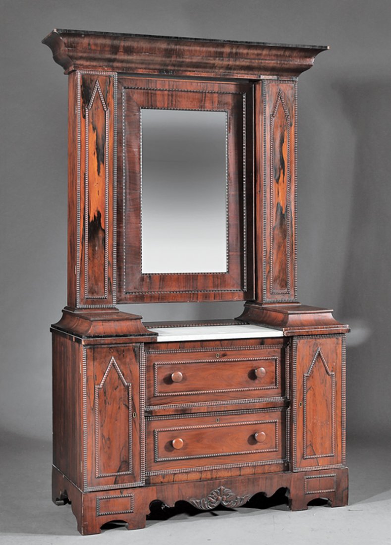 American Gothic Carved Rosewood Wig Dresser: American Gothic Carved Rosewood Wig Dresser, mid-19th c., ogee molded cornice, molded mirror flanked by gothicized cabinets; marble top with two glove boxes, over two drawers flanked by cabinets, shap