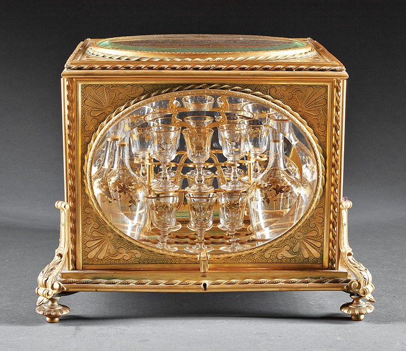 French Gilt Bronze and Glass Cave à Liqueur: French Gilt Bronze and Glass Cave à Liqueur, 19th c., scrollwork and floral hinged case, fitted interior with 4 decanters and 14 liqueur glasses, ball feet, h. 12 1/2 in., w. 16 in., d. 12 1/2 in. Pr