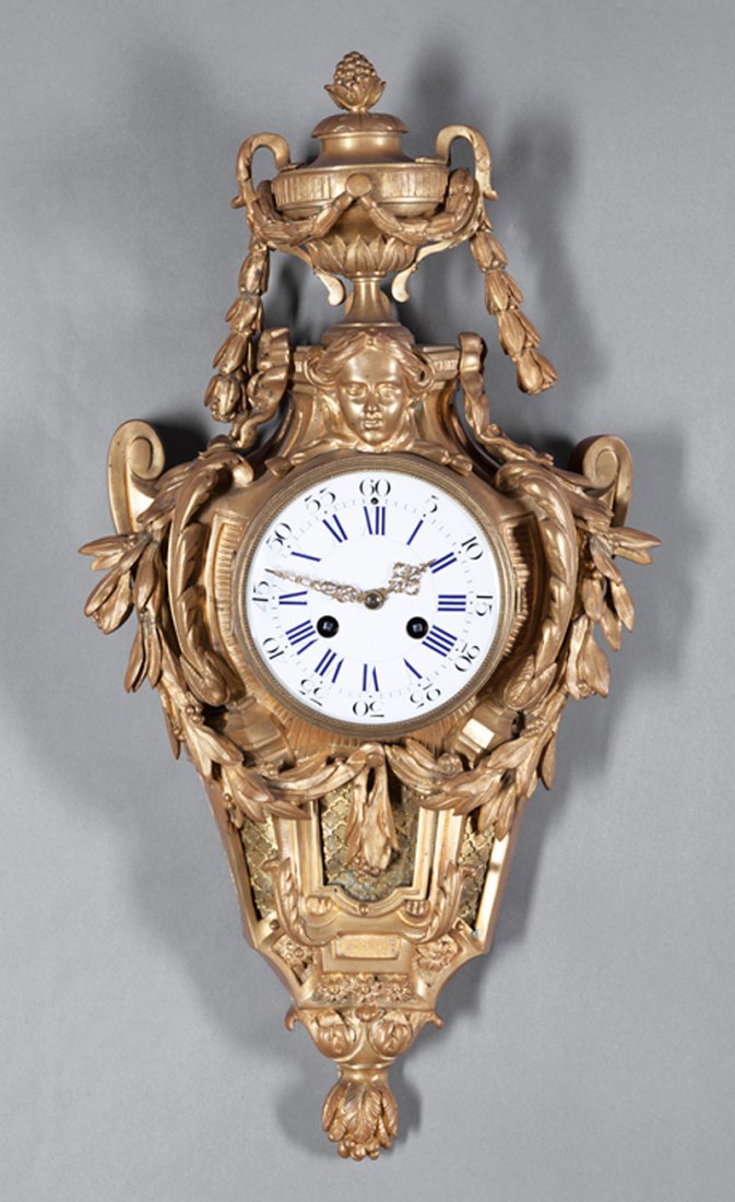 Beaux Arts Gilt Bronze Cartel Clock: Beaux Arts Gilt Bronze Cartel Clock in the Louis XVI Taste, c. 1900, enameled dial with cobalt Roman numerals, h. 22 in., w. 11 in., d. 4 1/2 in