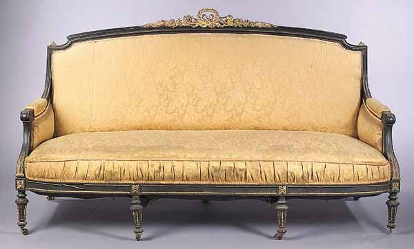 Pair of Napoleon III Settees: A Pair of Antique Napoleon III Ebonized and Bronze-Mounted Settees, mid-19th c., having a suppressed arch back mounted with floral beribonned crest, acanthus-carved arms, rounded seat rail and bronze