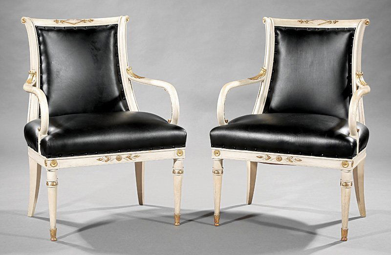 Maison Jansen Louis XVI-Style Fauteuils: Pair of Maison Jansen Louis XVI-Style Parcel Gilt and Creme Peinte Fauteuils, stamped, scrolled crests, leaf carved scrolled arms, paneled seat rail, turned tapered legs. h. 33 1/2 in., w. 23 6/9 in.,