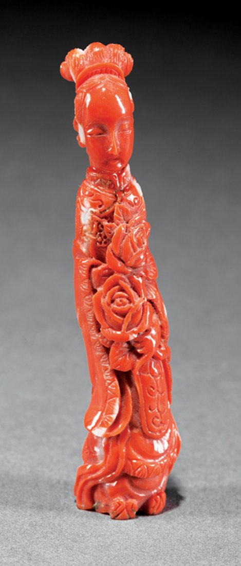 Chinese Coral Figure of a Beauty: Chinese Coral Figure of a Beauty, probably Qing Dynasty (1644-1911), carved wearing long robes and a celestial scarf, holding floral sprays, h. 3 in
