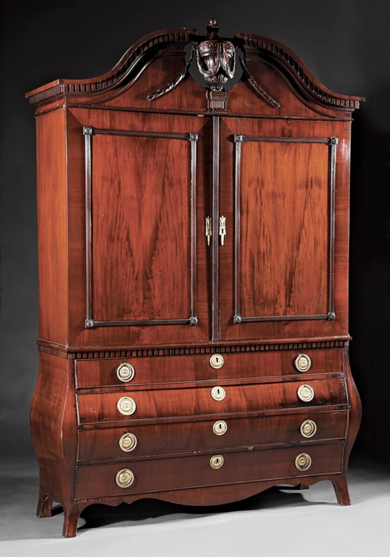 Dutch Carved Mahogany Press: Large Dutch Carved Mahogany Press in the Neoclassical Taste, 19th c., broken arch pediment with swags and urn, paneled doors with shelf interior, bombe lower case with four drawers, "French" feet, h. 