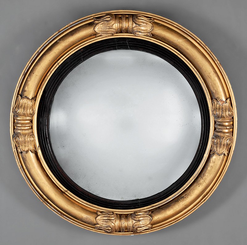 American Classical Carved Giltwood Bullseye Mirror: American Classical Carved Giltwood Bullseye Mirror, early 19th c., bolection molded lotus-carved surround, ebonized rabbet, convex mirror plate. d. 25 1/2 in.