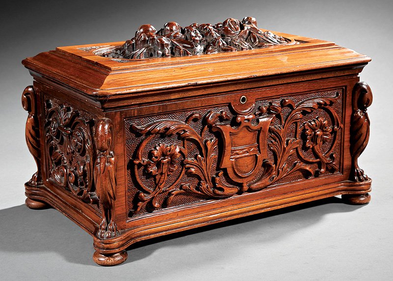 Renaissance Revival Carved Walnut Coffer: Renaissance Revival Carved Walnut Coffer, 19th c., lid with high relief cartouche, strapwork central crest, stiles with crane terms, bun feet, h. 10 in., w. 16 in., d. 10 in. Provenance: Film Prop fro
