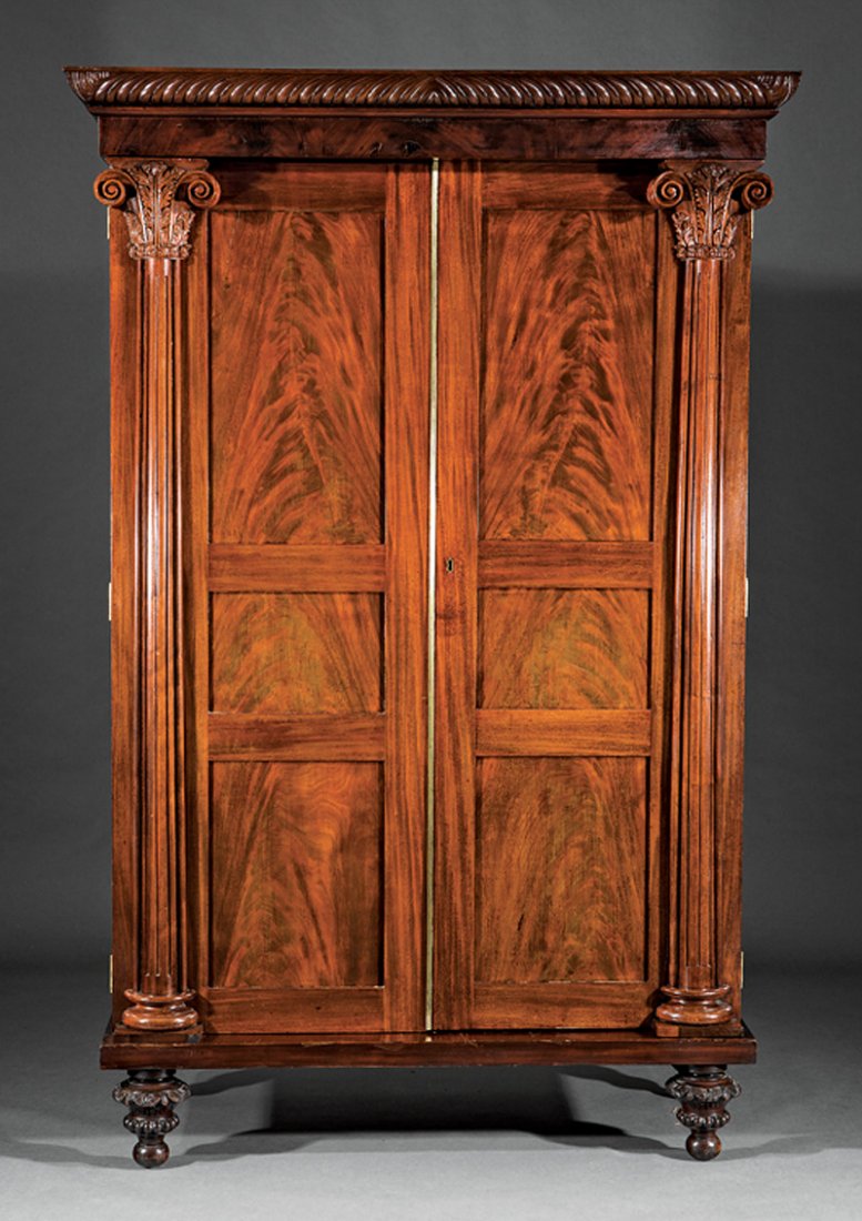 American Classical Carved Mahogany Armoire: American Classical Carved Mahogany Armoire, mid-19th c., New York, gadrooned cornice, figured frieze, recessed panel doors, fluted Corinthian column stiles, foliate carved feet, h. 89 1/2 in., w. 58 3