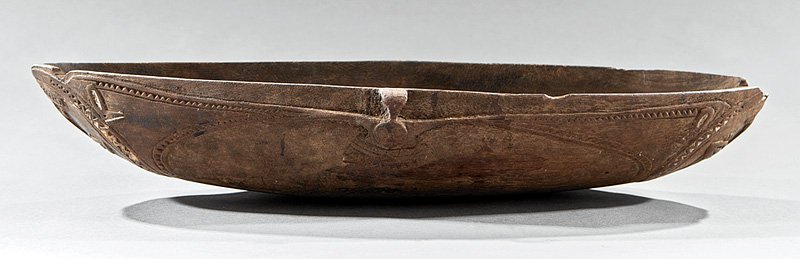 Two Oceanic Carved Wood Feasting Bowls: Two Oceanic Carved Wood Feasting Bowls, Tami Island, Guon Gulf, Papua New Guinea, first carved with stylized birds and alligators, h. 4 1/2 in., l 18 1/4 in.; second with stylized birds and faces, h. 