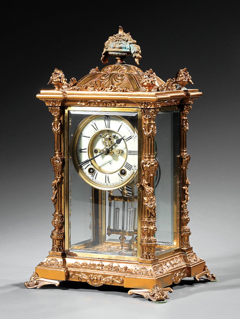 Ansonia Gilt Metal Crystal Regulator Clock: Ansonia Gilt Metal Crystal Regulator Clock, c. 1880, urn finials, fluted columns, beveled glass, visible escapement, faux mercury pendulum, h. 14 1/2 in., w. 8 3/4 in., d. 7 3/4 in. Provenance: The Se