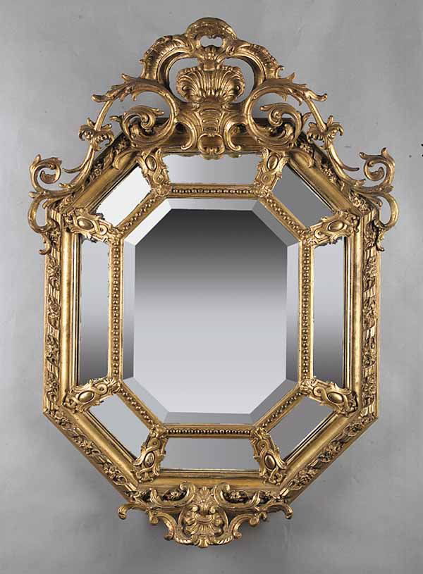 Fine Antique Continental Rococo Revival Giltwood: A Fine Antique Continental Rococo Revival Giltwood Mirror , mid-19th c., with bold shell and rocaille carved pierced crest above the octagonal frame with beaded, floral and ribbon moldings, and foliat
