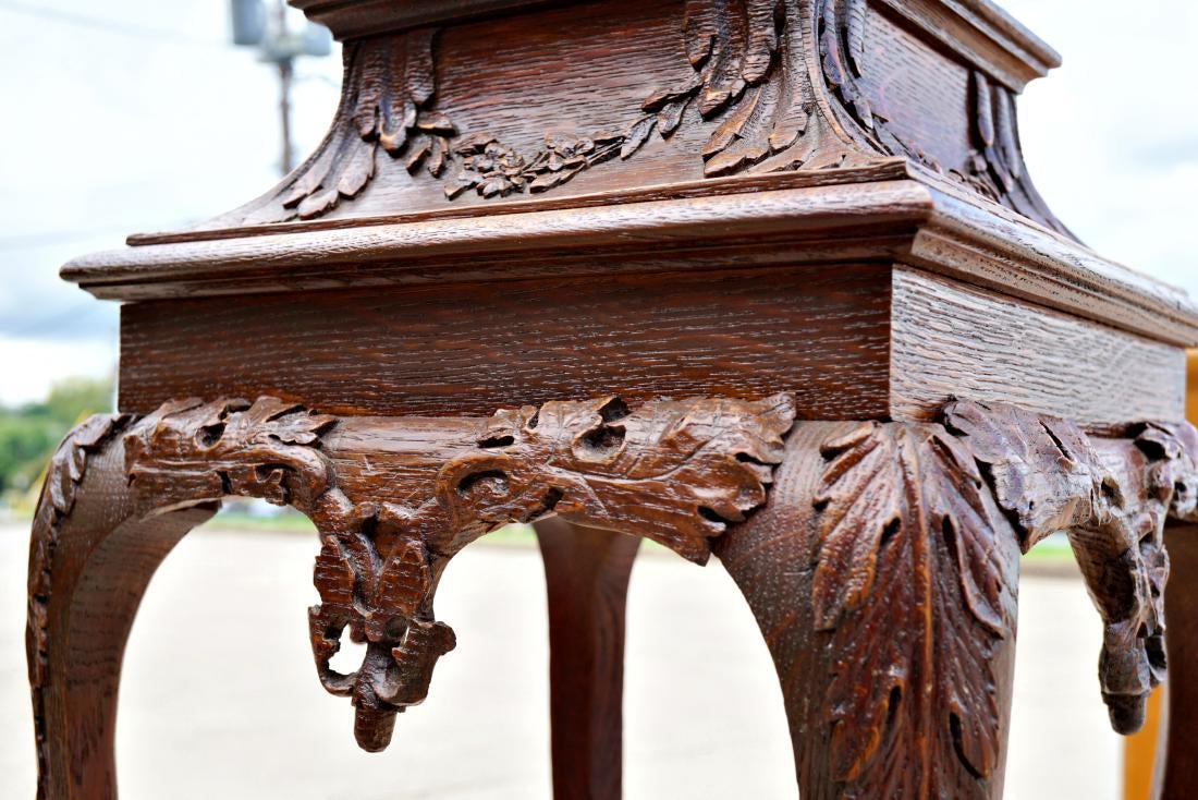Quarter Sawn Oak Plant Stand Pedestal: Quarter sawn oak pedestal/plant stand with ball and claw feet and trailing foliate detail. Ceramic inset top to protect the wood. Measures 45" tall, and 15" wide/deep at base.