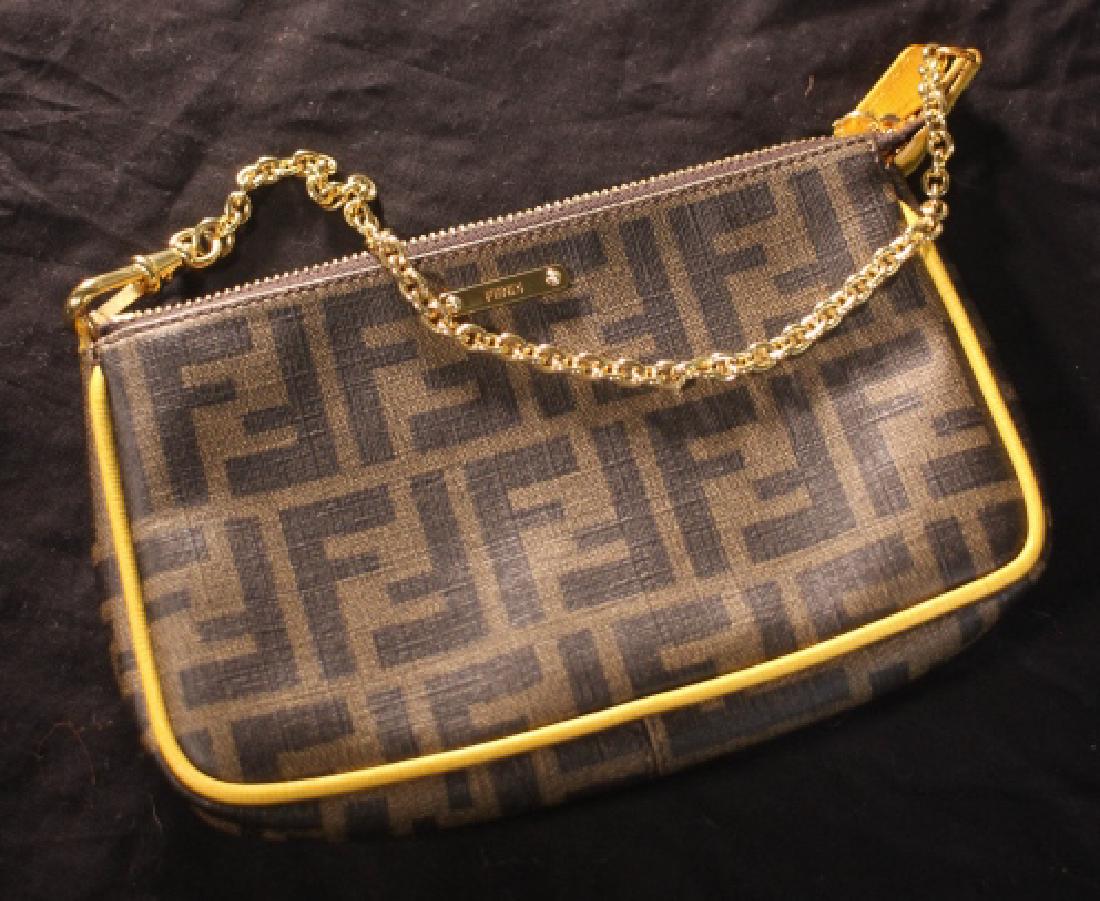 Fendi Tobacco Brown Zucca Coated Canvas Clutch: Women's Brown Tobacco Zucca Coated Canvas And Yellow Leather Convertible Clutch. Measures 8" x 5" with a 6" drop.