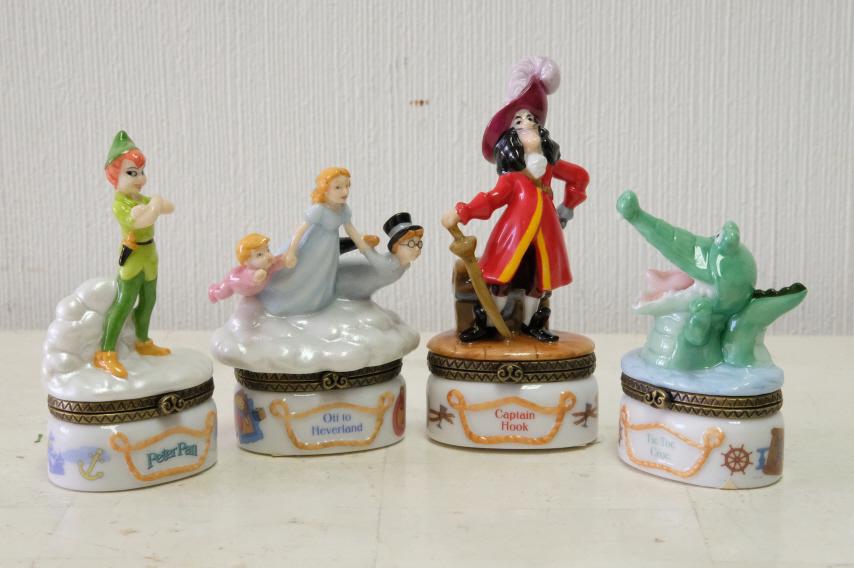 Four Disney "Peter Pan" Porcelain Trinket Boxes: Group of four Disney Midwest porcelain hinged trinket boxes from Peter Pan comprising "Tic Toc Croc", "Peter Pan", "Captain Hook" and "Off to Neverland".Each box with a 'surprise' inside.