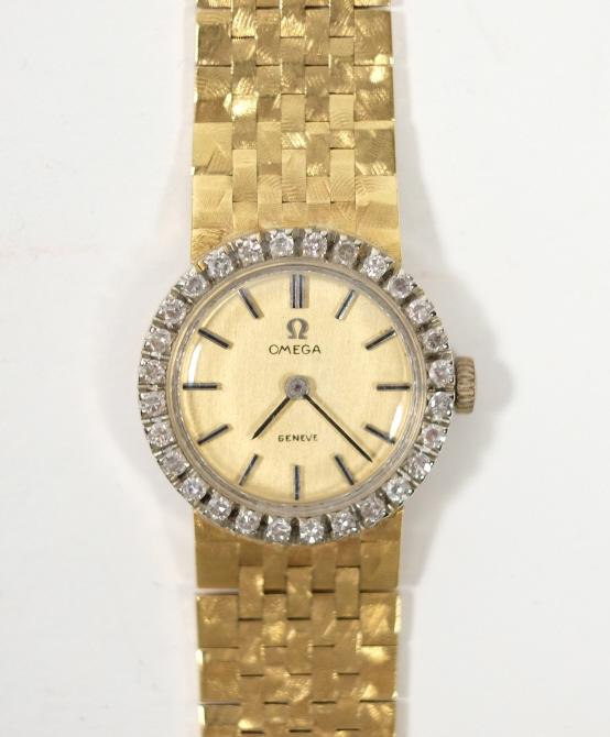 18k YG Ladies Omega w/ Diamonds: 18k Yellow gold Art Deco Omega wrist watch with brilliant cut white diamond bezel. Total weight is 41.54g.