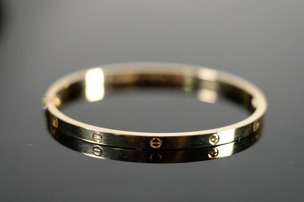 LOVE SM Bracelet in 18k YG sz 17: 18k Yellow gold hinged LOVE SM bangle bracelet.Bears the signature of Cartier and hallmarks and serial number. Size 17 and weighs a total of 20.89 grams. Sold without paperwork.
