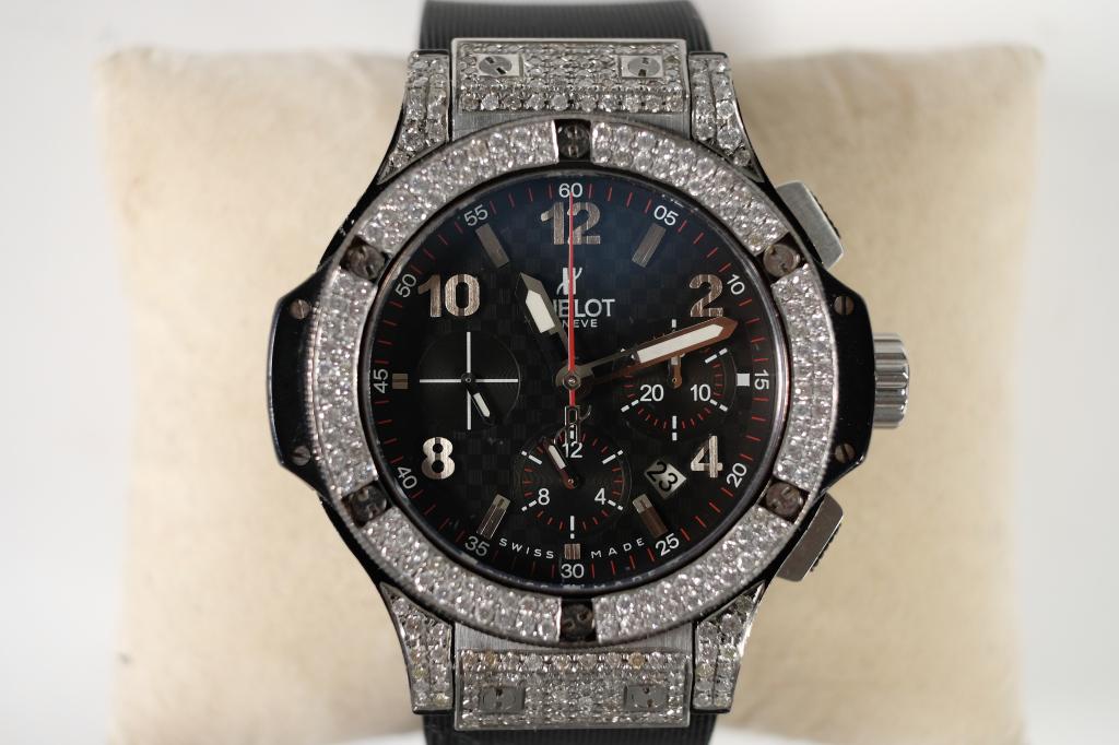 Hublot Big Bang with Diamonds and Carbon Fiber: Hublot Big Bang chronograph with diamond bezel and case, rubber strap, sapphire case back, and carbon fiber face. Weighs a total of 150 grams.