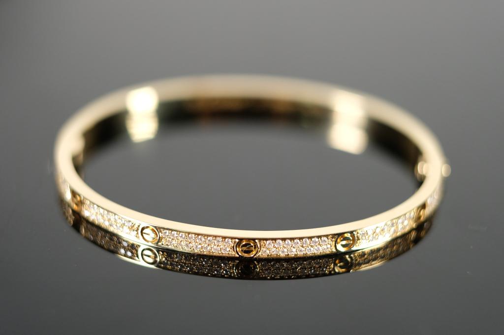 LOVE SM Bracelet in 18k YG w/ Pave Diamonds sz 17: 18k Yellow gold thin hinged LOVE SM bangle bracelet with full pave VS clarity white diamonds. Bears the signature of Cartier and hallmarks and serial number. Size 17 and weighs a total of 20.90 grams.