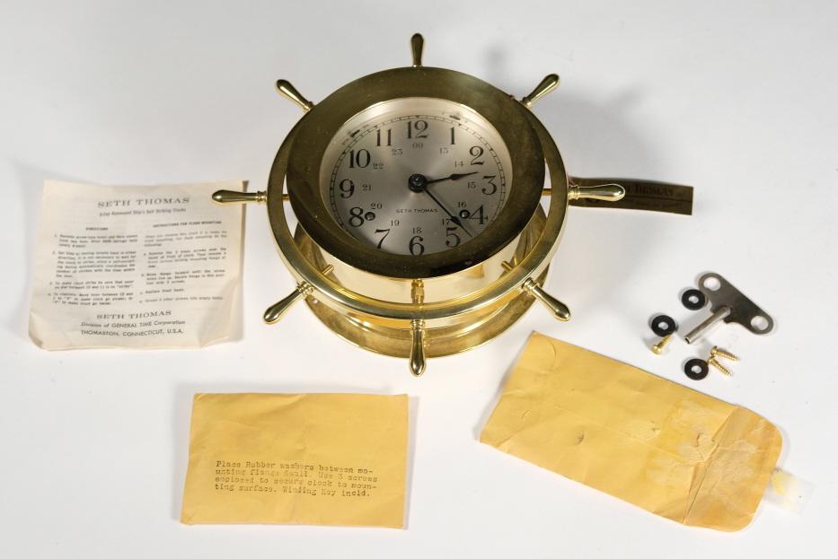 Vintage Seth Thomas Brass Ship's Wheel Clock: Seth Thomas 8 -Day key wound Ship's Bell striking clock in brass with silvered dial; E537-001 Helmsman.Overall diameter 8.5”, dial diameter 4".